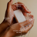 Koji White AHA exfoliating soap bar, 0.88 oz, four bars, with natural ingredients, visible exfoliating texture and packaging.