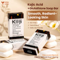 Two bars of Kojiwhite Kojic Acid and Glutathione skin brightening soap, showing the soap's packaging and brand label.