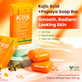 Two bars of Kojiwhite Kojic Acid and Papaya Skin Brightening Soap with papaya extract, shown in a clear view.
